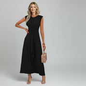 woman wearing black summer maxi dress on a plain background