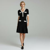 woman wearing black elegant midi dress on a plain backgorund