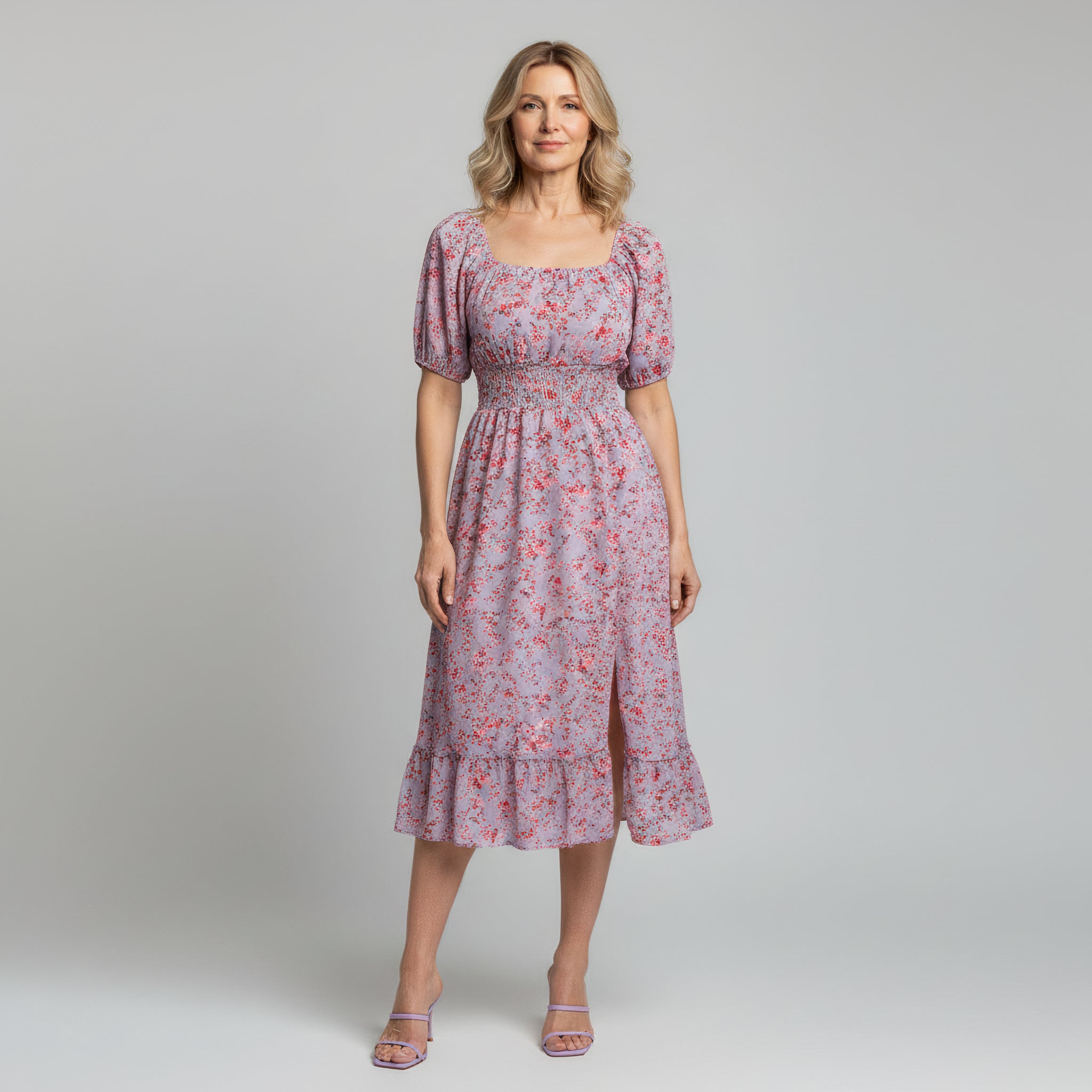 woman wearing purple maxi dress on a plain background