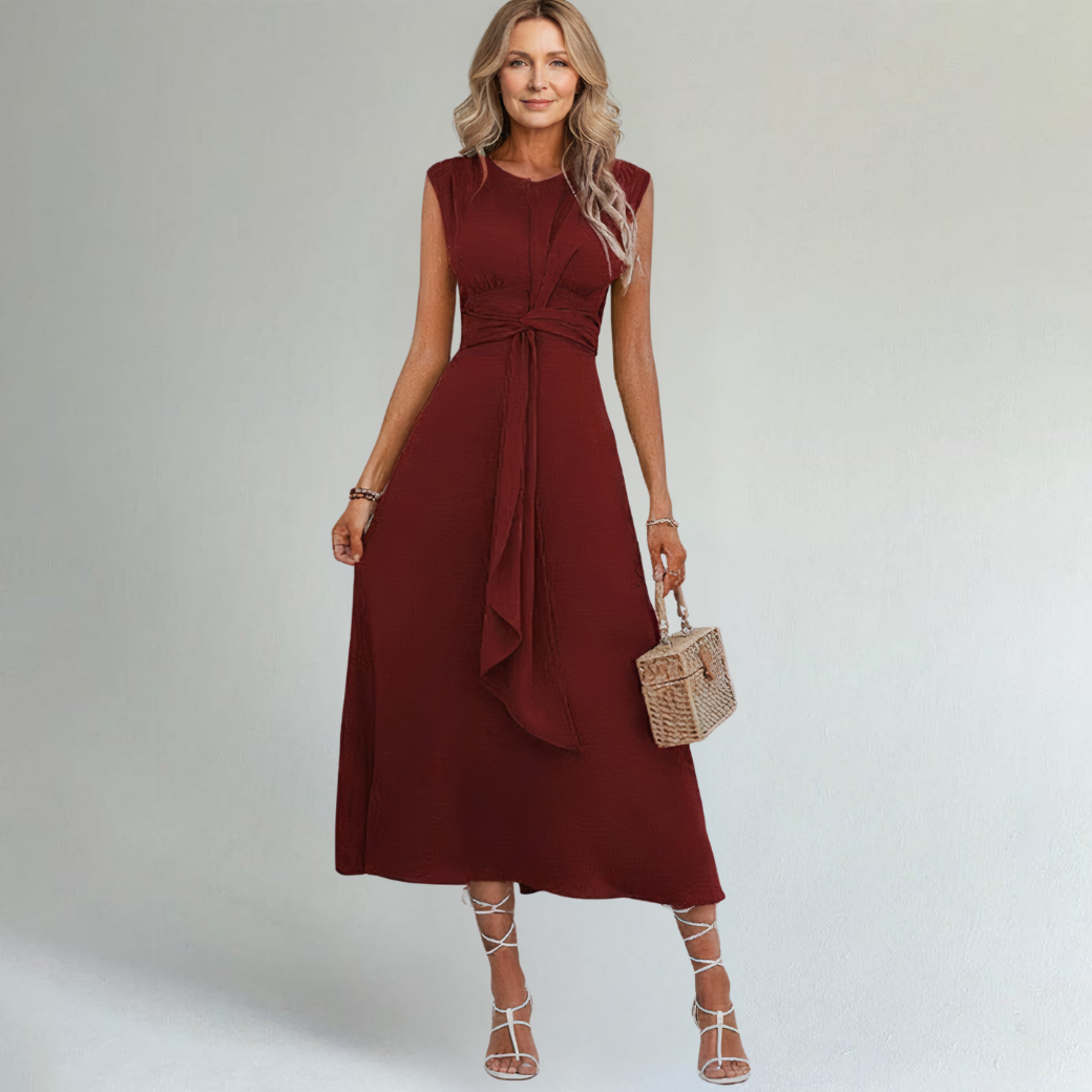 woman wearing maroon maxi dress on a plain background