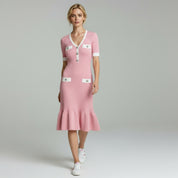 woman wearing pink elegant midi dress on a plain background